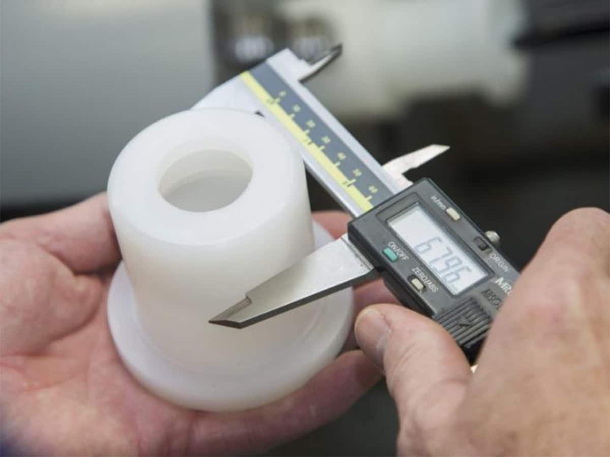 Engineer inspecting molded part defects